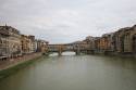 The Ponte Vecchio crosses the Arno River, same river with goes through Pisa