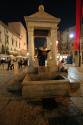 Ancient Roman well in the middle of the Piazza. Behind is a stone canopy where, in ancient times, they kept the scales shared by all the traders.